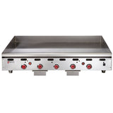A large commercial stainless steel countertop gas griddle with four red control knobs and a raised backsplash, designed for restaurant use. The front panel features the Wolf brand logo and indicator lights above each knob.