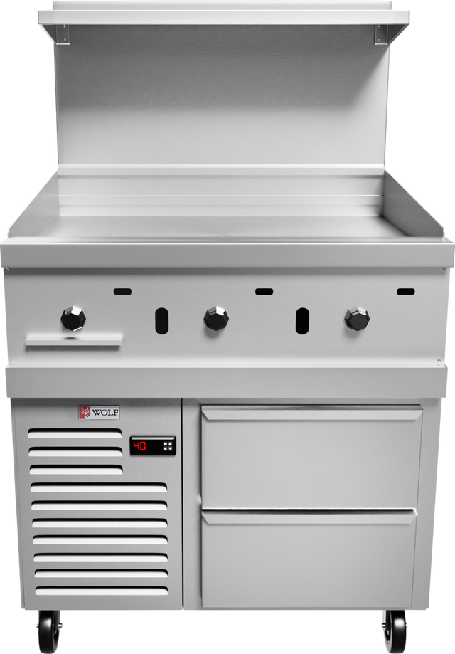 A commercial stainless steel integrated griddle with three control knobs, a backsplash, shelf, storage drawers, and digital display on the left, set on four caster wheels—ideal for professional kitchen use as part of a Wolf Challenger XL Restaurant Range.