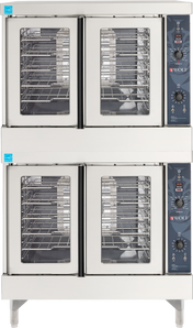 A double-stacked Wolf WC44GD convection oven with four glass doors—two per oven. Each stainless steel unit features multiple metal racks and a control panel with dials, buttons, and the Wolf logo, ideal for any commercial kitchen equipment lineup.