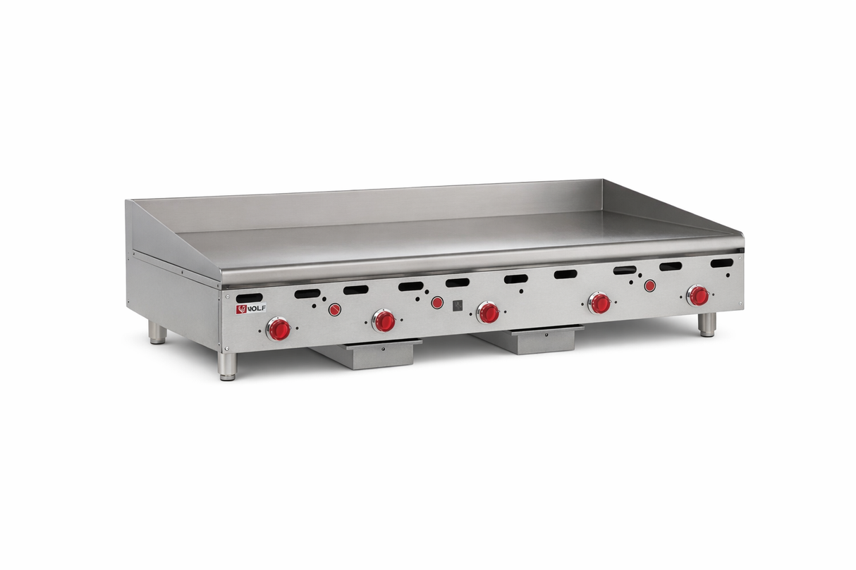 A heavy duty commercial griddle with six red control knobs, raised splatter guards, and sturdy metal legs. This countertop gas griddle features a flat stainless steel surface for cooking multiple items at once.