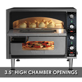 A stainless steel double-deck pizza oven with its door open shows six golden buns baking inside. The control panel features knobs and indicator lights, while a pizza is visible through a lower window. Text at the bottom reads, “3.5” HIGH CHAMBER OPENINGS.”.