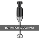 A black and silver medium duty immersion blender is centered on a white background. The words “LIGHTWEIGHT & COMPACT” are in large white letters across a gray band behind the blender, which features a simple on/off switch labeled “LOW.”.