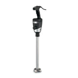 A heavy duty immersion blender with a black handle, control buttons, and ventilation slits. It features an 18" stainless steel shaft ending in a metal blade guard with visible blades. The power cord extends from the top handle.