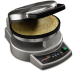 A silver, round tortilla press labeled “Xpress” features a digital display showing 450°F. The upper lid is open, revealing a cooked tortilla inside. This multipurpose cooktop has control buttons, a green switch, and a modern design.