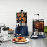 A kitchen counter displays a stainless steel 1-gallon syrup dispenser and a waffle batter dispenser, both with blue bases and waffle images. A waffle maker and a plate with waffles, strawberries, blueberries, and whipped cream are also shown.