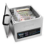 A Waring 16-liter Sous Vide Circulating Water Bath with a stainless steel finish, digital display at 135°F and 2:00, and partially open lid. Several vacuum-sealed bags are submerged in its rectangular basin.