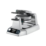 A stainless steel Waring Belgian waffle maker with double non-stick plates, a rotary feature, black handles, and digital controls on the front panel. The round waffle plates are mounted horizontally within the machine against a white background.
