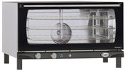 A stainless steel Cadco countertop convection oven with a glass front door, three metal racks inside, control knobs and indicator lights below the door, and four short legs for stability. The brand name is displayed on the bottom right corner.