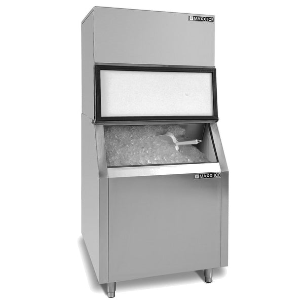 A commercial stainless steel ice machine with an open top ice storage bin filled with ice. A white plastic scoop rests on the ice. The unit stands on four legs, is rectangular, and labeled “MAXX ICE,” boasting a 580 lbs ice capacity.